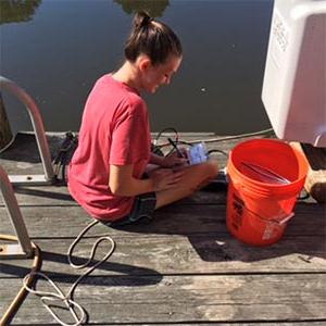 female student sitting on dock